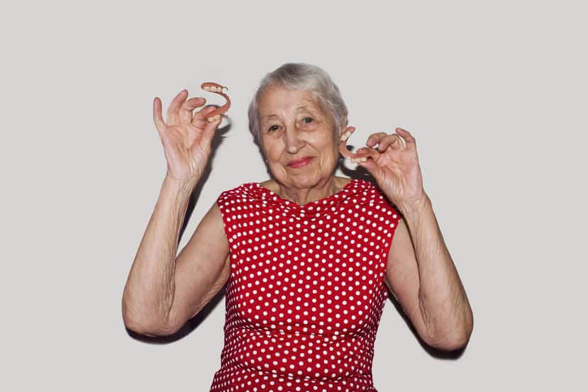 Woman Holding Dentures Image